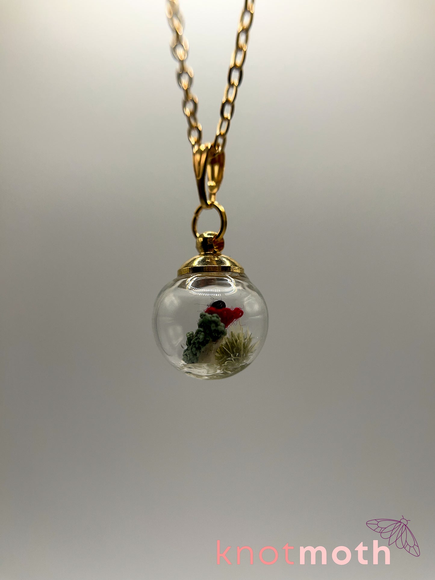 poppy flower & vertebra bone micro crochet mini globe necklace