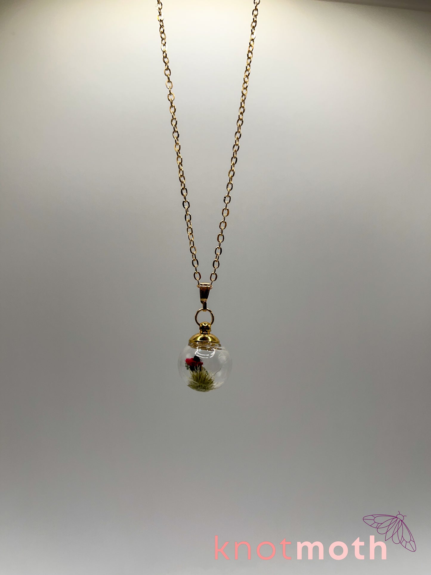 poppy flower & vertebra bone micro crochet mini globe necklace