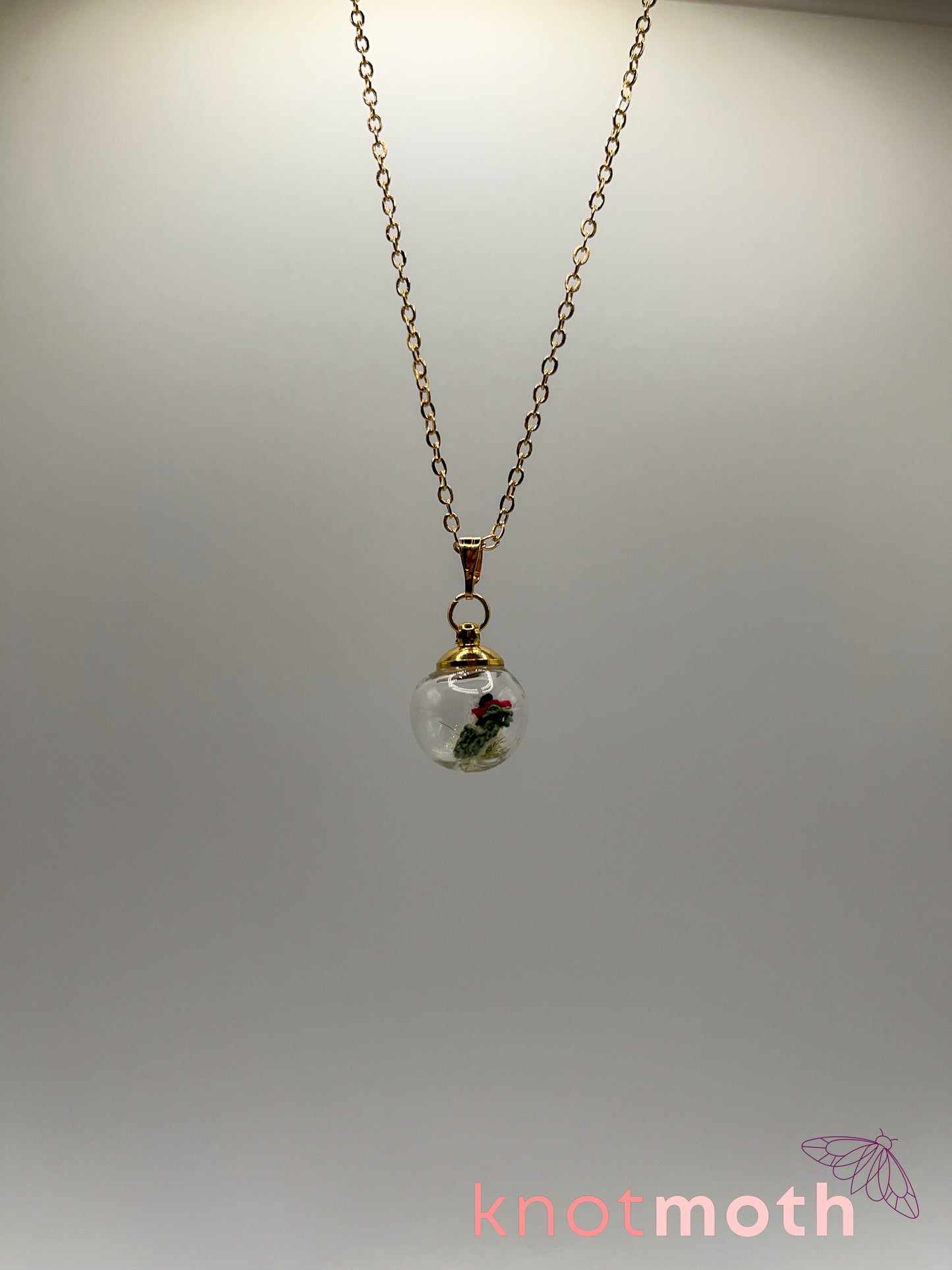 poppy flower & vertebra bone micro crochet mini globe necklace