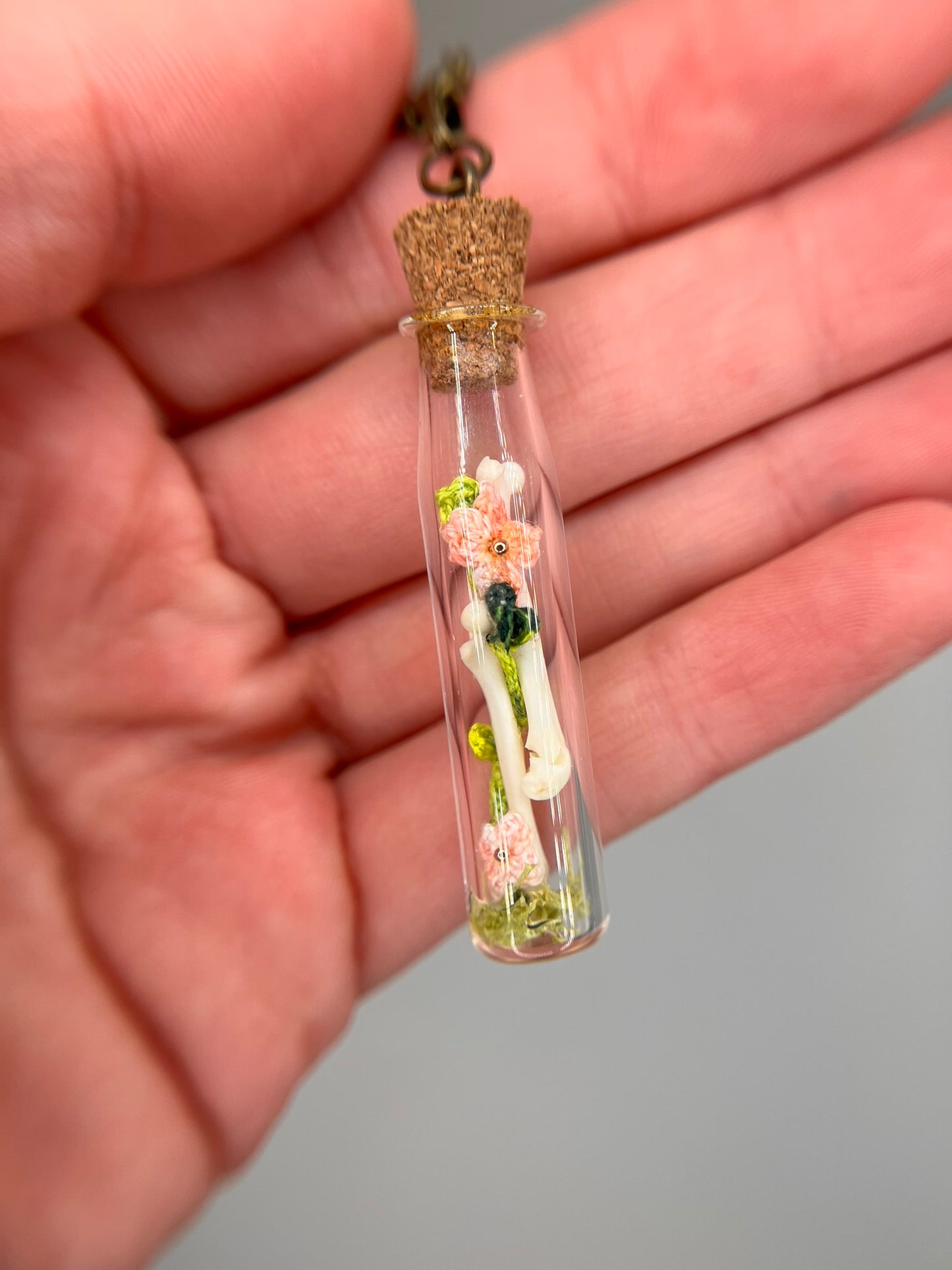 flowers, vine, & paired femora - bone garden vial necklace