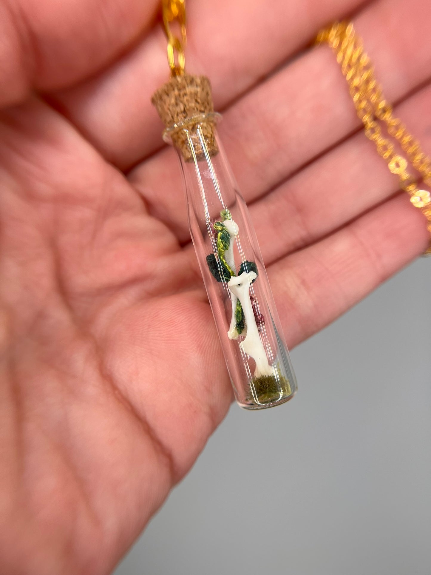 flowers, vine, & paired humeri - bone garden vial necklace